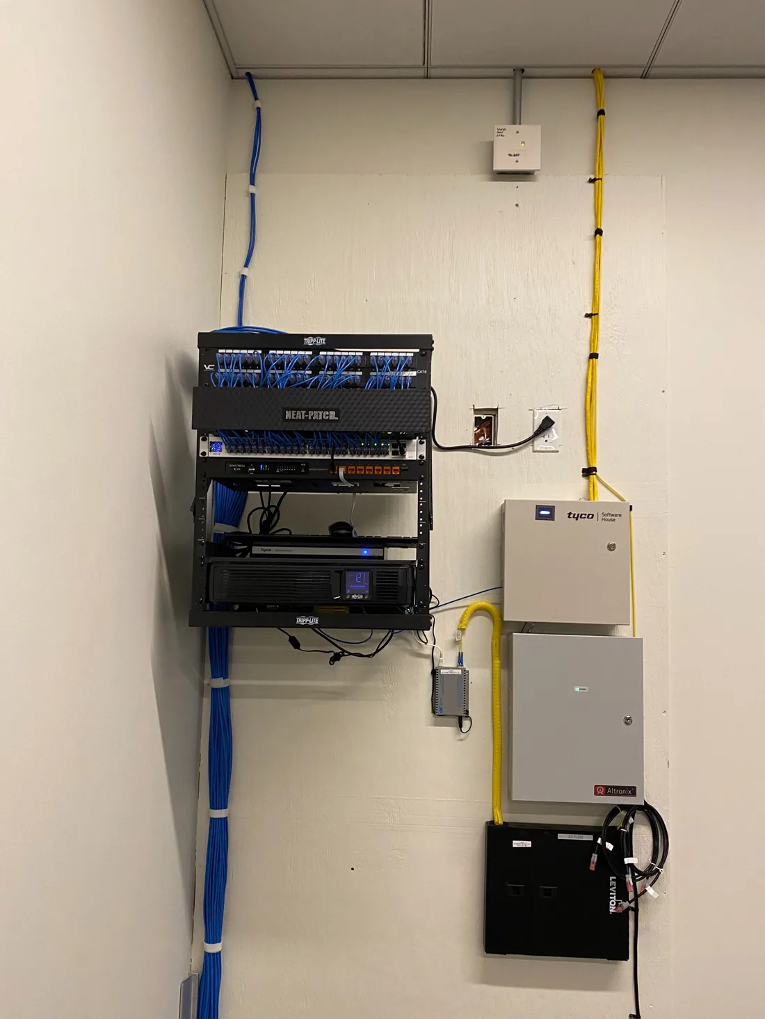 Completed wall-mounted network rack buildout